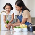 Kitchen,,Mother,And,Child,Washing,Vegetable,To,Cook,Dinner,,Lunch